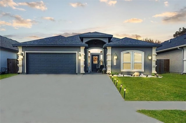 prairie-style house with a garage and a yard