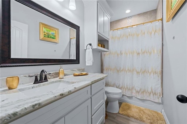 full bathroom with hardwood / wood-style flooring, vanity, shower / bath combo, and toilet