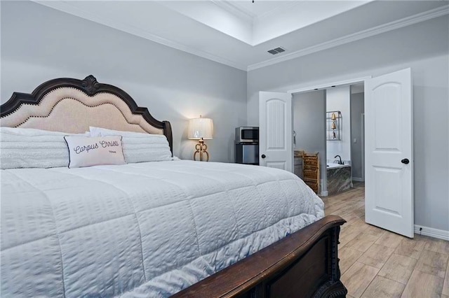 bedroom featuring ornamental molding and light wood-type flooring