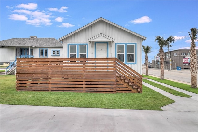 view of front of property with a front yard and a deck