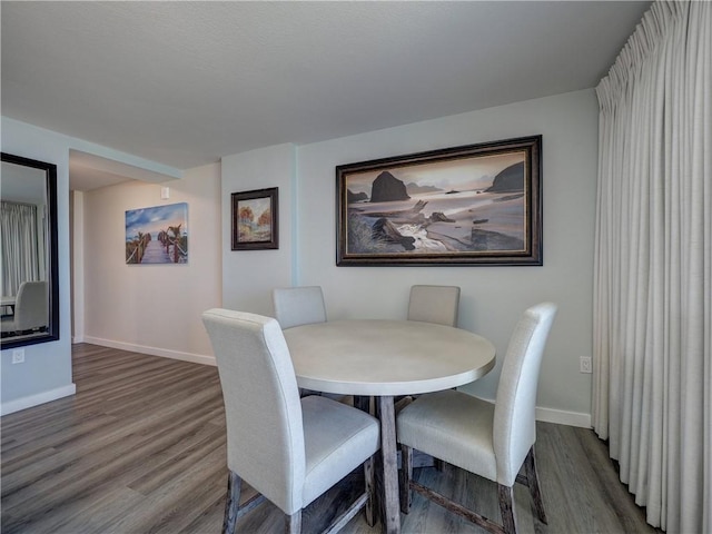 800 Sandcastle Dr Unit 308, Port Aransas, TX 78373 - dining room featuring wood finished floors and baseboards