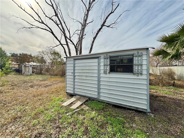 view of shed with fence