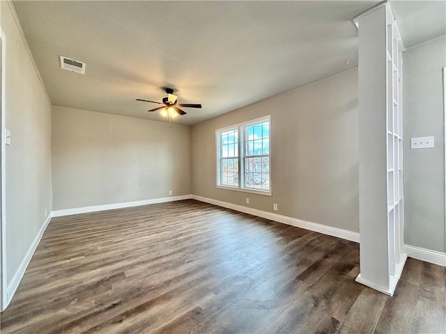 empty room featuring ceiling fan and dark hardwood / wood-style flooring