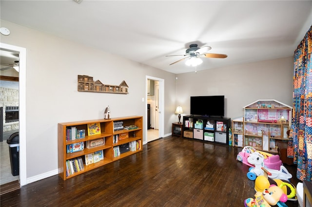 playroom featuring dark wood-type flooring and ceiling fan