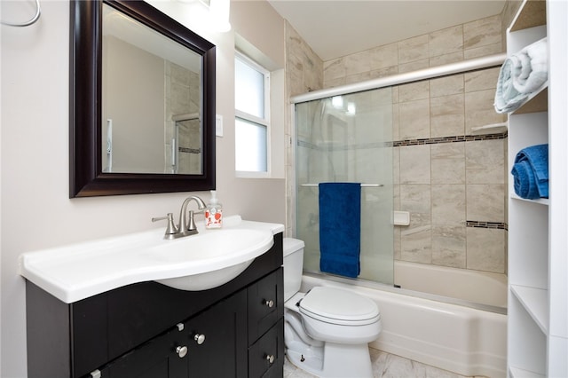 full bathroom featuring bath / shower combo with glass door, vanity, and toilet