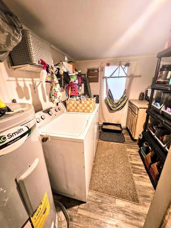 402 E Nopal St, Rockport, TX 78382 - laundry room with laundry area, washer and clothes dryer, water heater, and wood finished floors