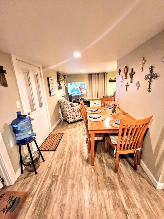 402 E Nopal St, Rockport, TX 78382 - dining space with baseboards and light wood-style flooring