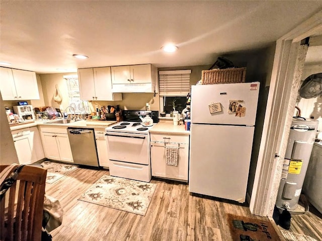 402 E Nopal St, Rockport, TX 78382 - kitchen with light countertops, a sink, under cabinet range hood, white appliances, and electric water heater