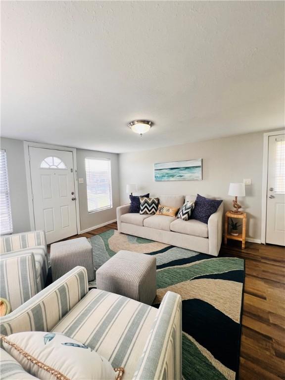 402 E Nopal St, Rockport, TX 78382 - living area featuring a textured ceiling, baseboards, and wood finished floors