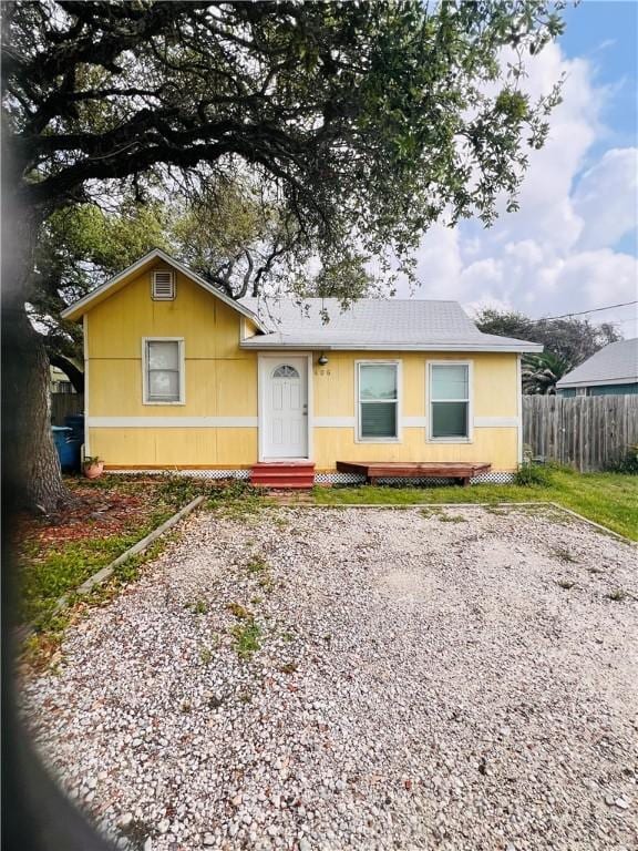 402 E Nopal St, Rockport, TX 78382 - view of front facade with fence and driveway