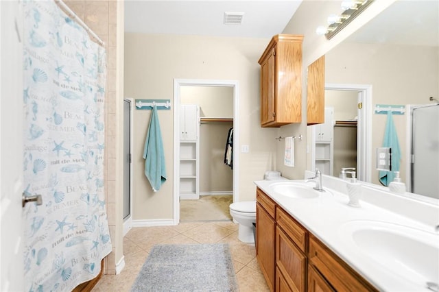 13706 Sea Horse Ave, Corpus Christi, TX 78418 - bathroom featuring a shower stall, a spacious closet, double vanity, and tile patterned floors