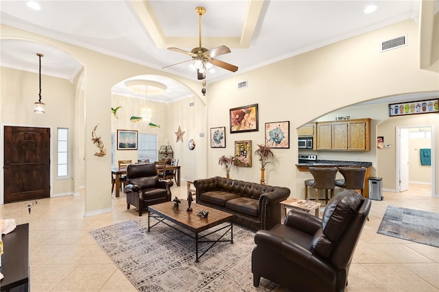 living room with ceiling fan, light tile patterned flooring, and crown molding