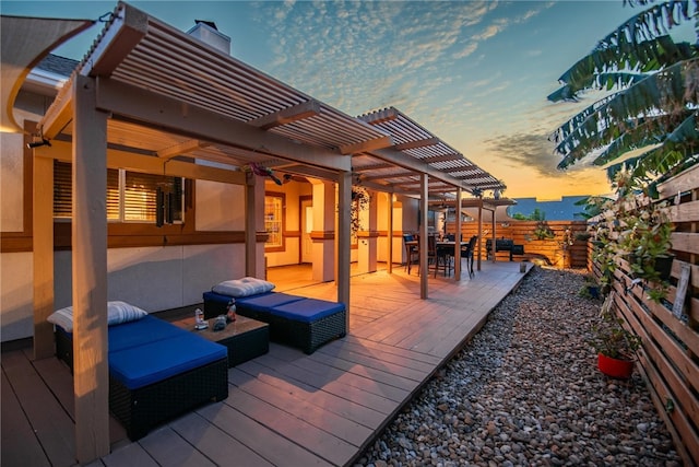 deck at dusk with outdoor lounge area and a pergola