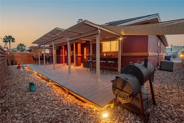 13706 Sea Horse Ave, Corpus Christi, TX 78418 - back of house at dusk featuring a pergola, a wooden deck, and a chimney