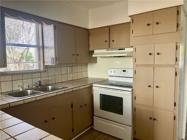 kitchen with tile countertops, white electric range oven, backsplash, and sink