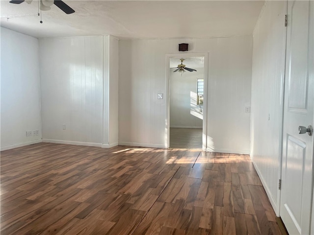 unfurnished room featuring ceiling fan and dark hardwood / wood-style floors