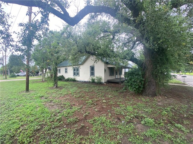 view of property exterior featuring a lawn