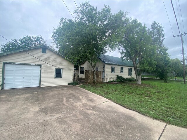 view of front of property with a garage and a front yard