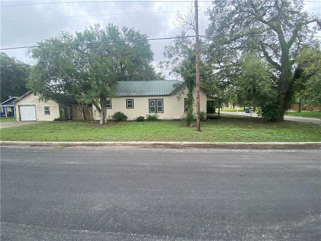 view of front of home with a garage and a front yard