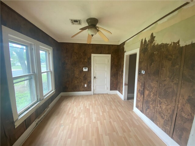 unfurnished sunroom featuring ceiling fan