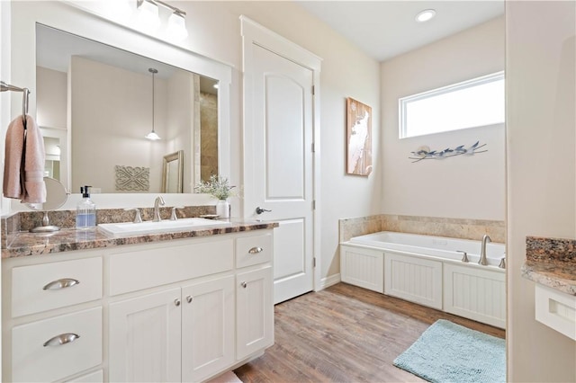 502 Sailhouse Way, Rockport, TX 78382 - full bath with a bath, baseboards, vanity, and wood finished floors