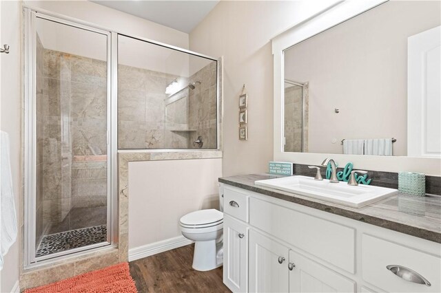502 Sailhouse Way, Rockport, TX 78382 - bathroom featuring vanity, wood finished floors, a shower stall, and toilet