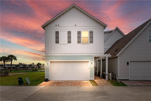 502 Sailhouse Way, Rockport, TX 78382 - view of front facade featuring decorative driveway, board and batten siding, and a garage