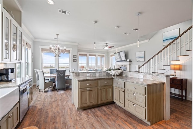 502 Sailhouse Way, Rockport, TX 78382 - kitchen featuring dishwasher, visible vents, dark wood-type flooring, a fireplace, and ceiling fan with notable chandelier