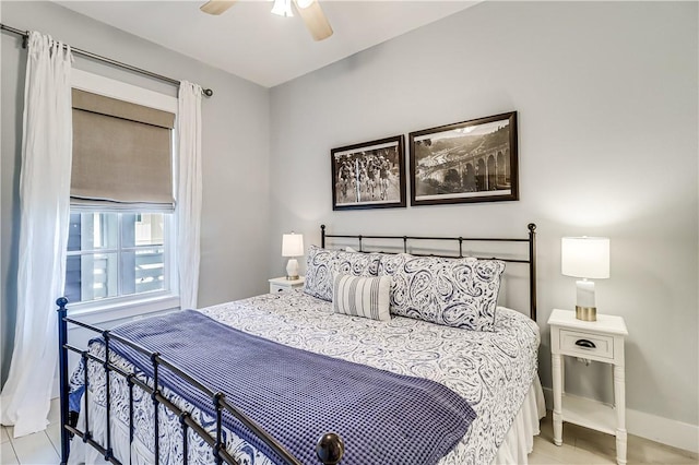 bedroom with a ceiling fan and baseboards