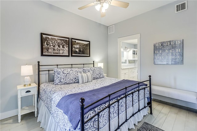 bedroom featuring baseboards, ceiling fan, visible vents, and connected bathroom