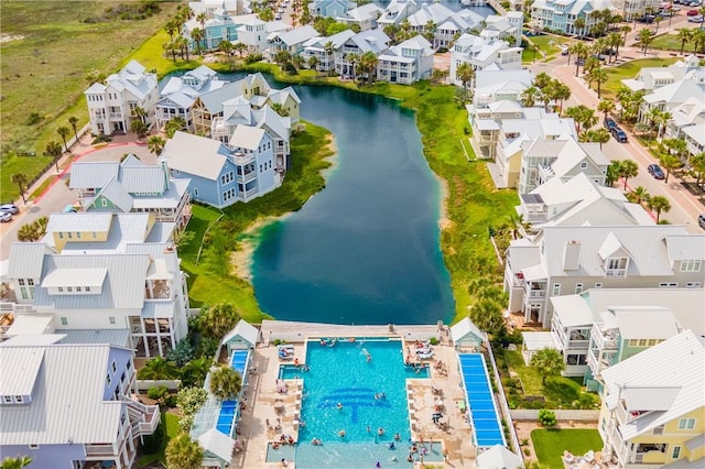 aerial view of residential area with a pool area and a nearby body of water