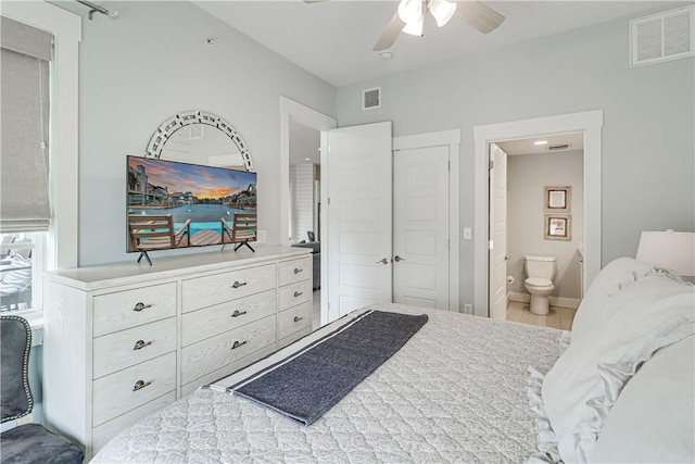 bedroom with ensuite bathroom, baseboards, visible vents, and a ceiling fan