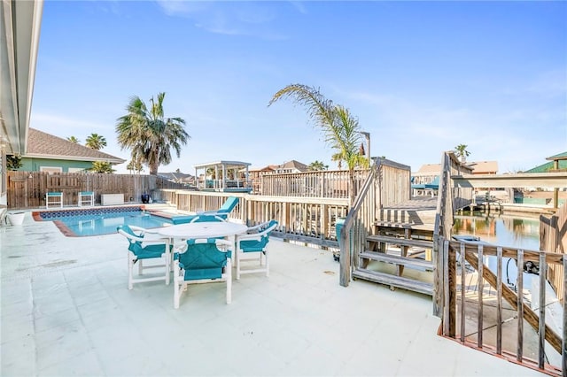 view of swimming pool with a fenced in pool, fence, and a patio