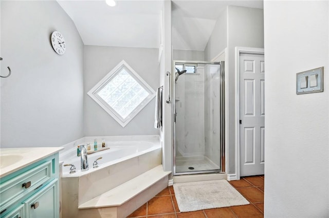 full bathroom with a stall shower, a garden tub, vanity, and tile patterned floors