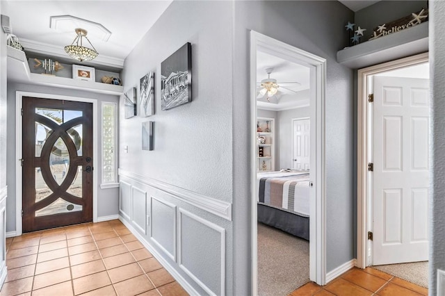 entryway featuring baseboards and light tile patterned flooring