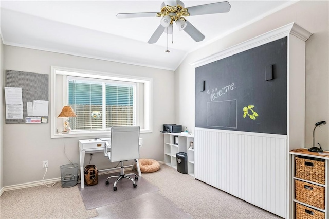 carpeted home office with lofted ceiling and a ceiling fan