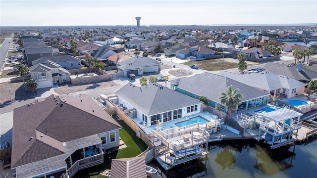 birds eye view of property featuring a water view and a residential view