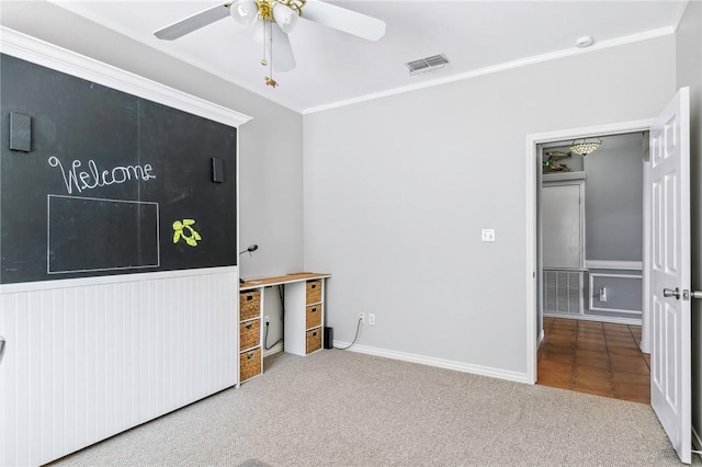 interior space with a ceiling fan, visible vents, and crown molding