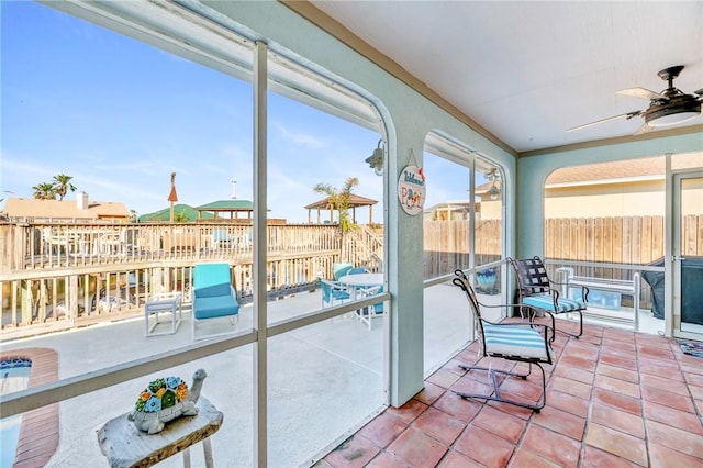 sunroom featuring a ceiling fan