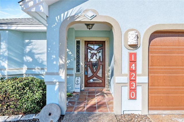 doorway to property with stucco siding