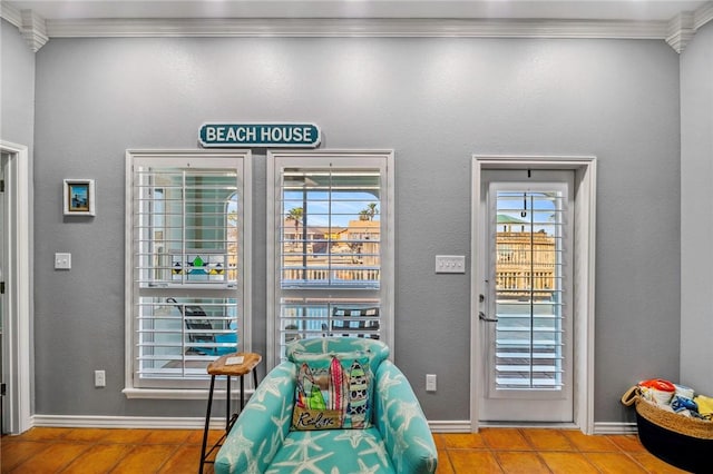 sitting room featuring crown molding and baseboards