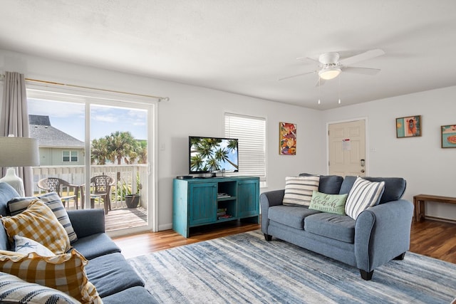 living room featuring ceiling fan and wood-type flooring