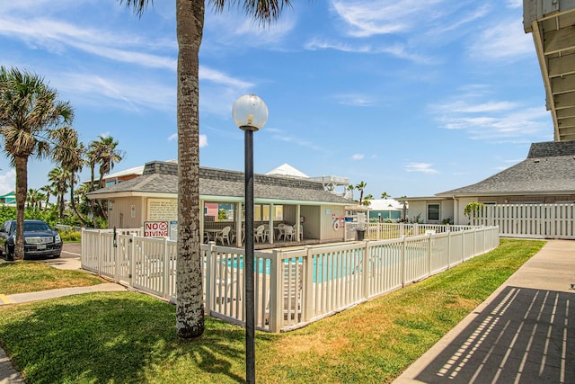 view of pool with a yard