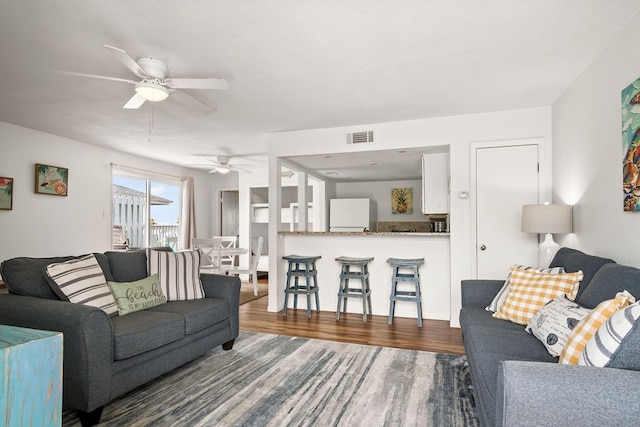 living room with dark hardwood / wood-style floors and ceiling fan