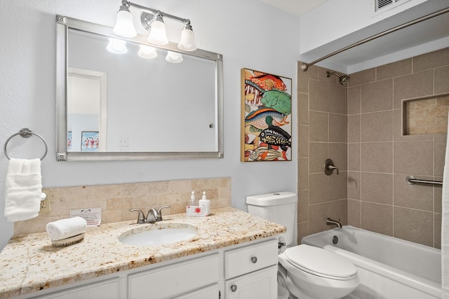 full bathroom featuring vanity, toilet, backsplash, and tiled shower / bath