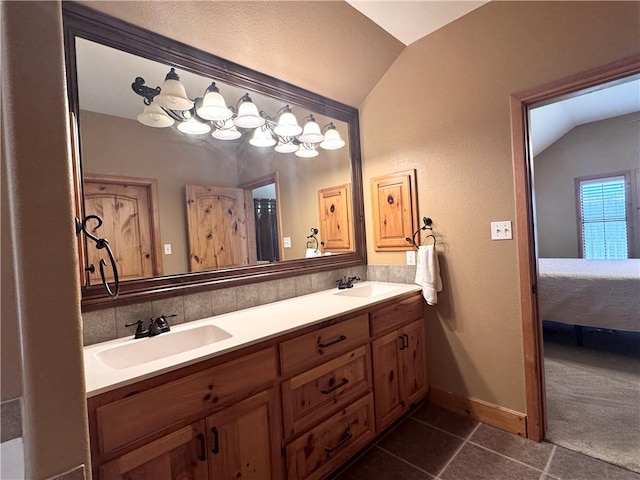 7605 Bayonne Dr, Corpus Christi, TX 78414 - ensuite bathroom featuring vaulted ceiling, double vanity, and tile patterned flooring