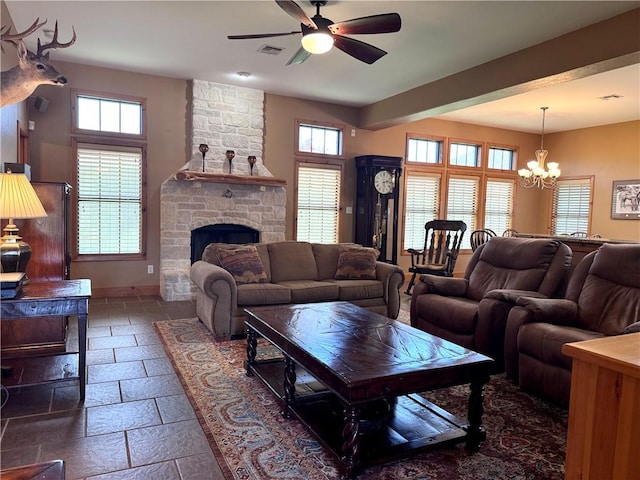 7605 Bayonne Dr, Corpus Christi, TX 78414 - living area featuring healthy amount of natural light, a ceiling fan, stone tile floors, and a chandelier