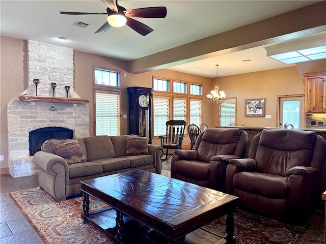 7605 Bayonne Dr, Corpus Christi, TX 78414 - living area featuring a chandelier, a ceiling fan, and a stone fireplace