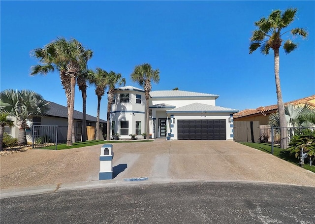 view of front of home featuring a garage, fence, concrete driveway, and stucco siding