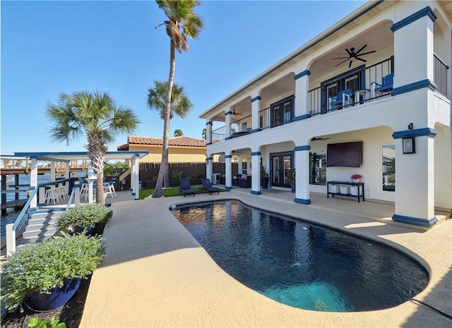 view of swimming pool featuring a patio area, ceiling fan, and a pergola